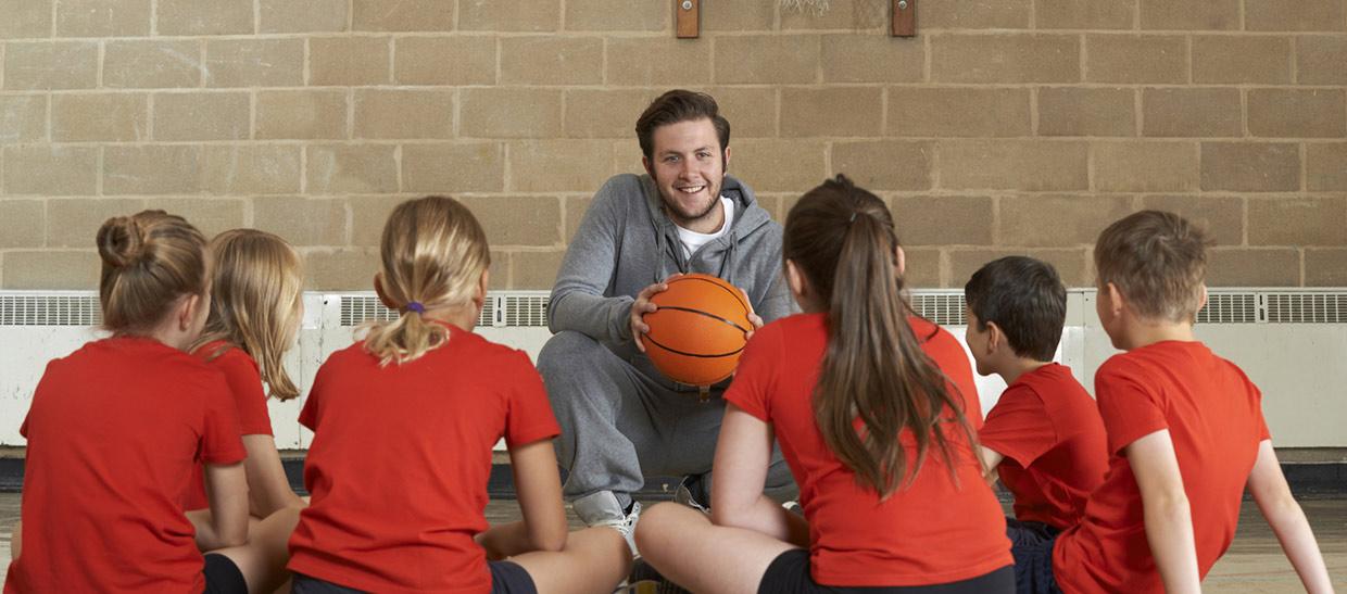 A coach with his basketball players